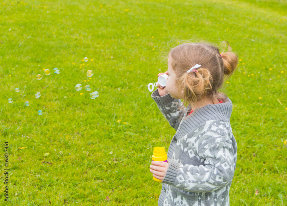 in the Park baby girl blow bubbles. in the Park baby girl blow bubbles.