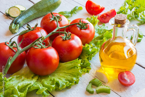 Ingredients for salad: tomatoes, olive oil and lettuce