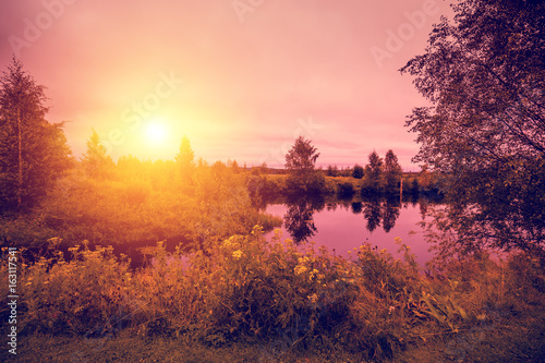Lakeshore with reflection in the autumn morning. Beautiful idyllic autumn nature. Rovaniemi, Finland.