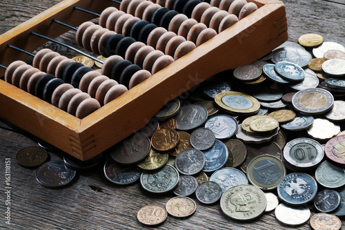 Wooden abacus and a bunch of different coins