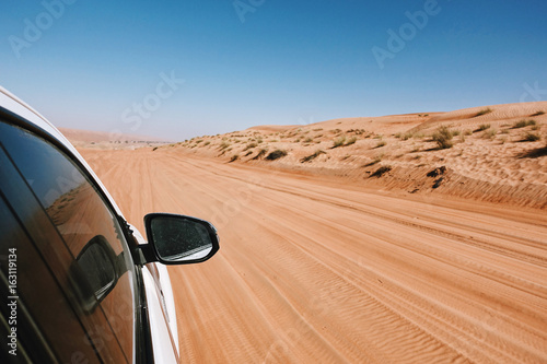 Point of view from the window off-Road car ride on road in desert area, Oman