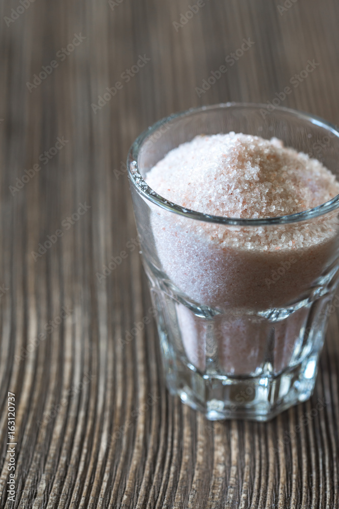 Glass of pink sea salt