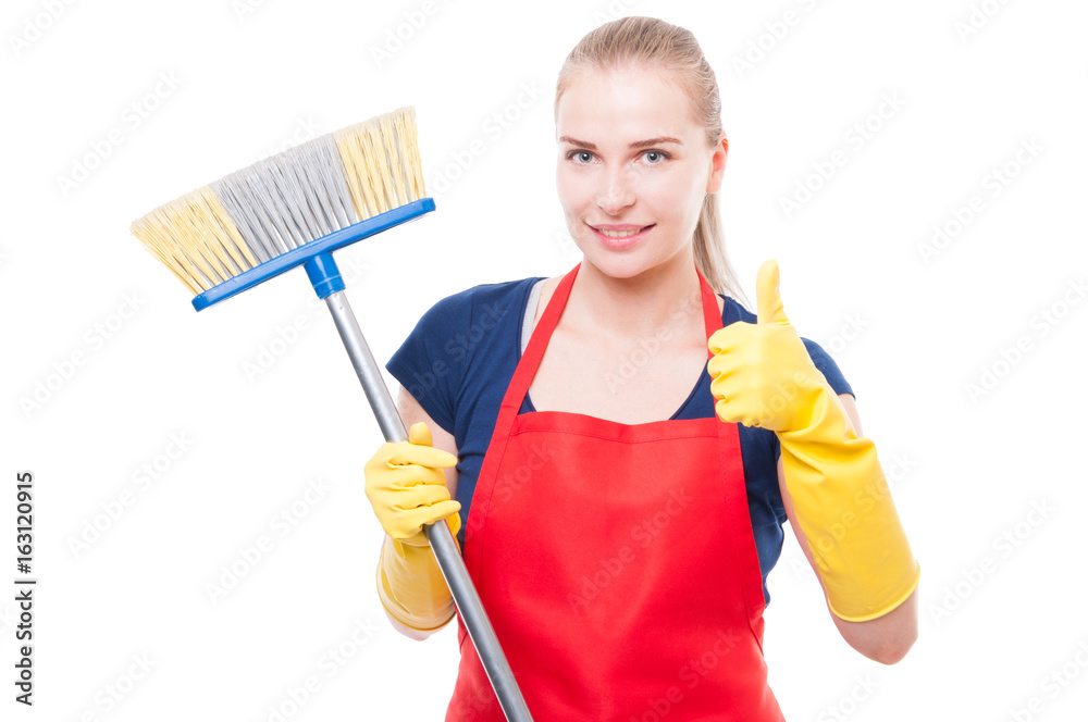 Attractive woman holding broom and smiling at camera Attractive woman holding broom and smiling at camera