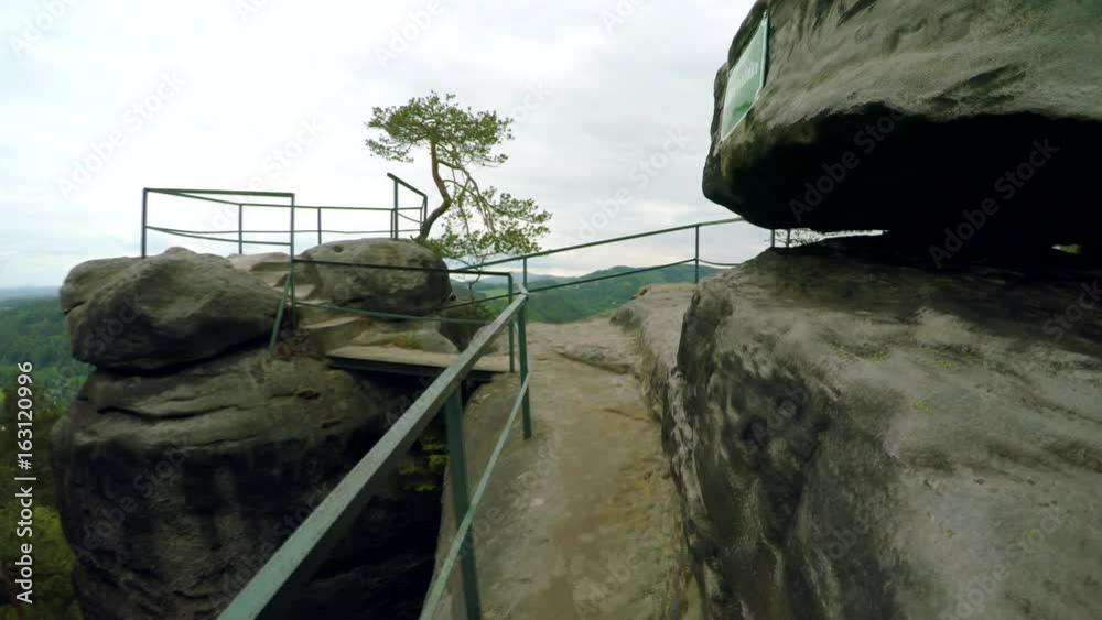 Walking up to the top of the rock with lookout. National Park Cesky Raj (Bohemian Paradise) in Czech Republic.