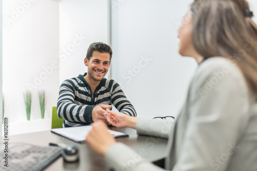 Man signing document in office