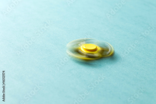 Yellow fidget spinner rotates