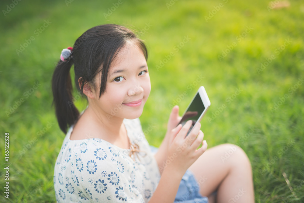 Beautiful Asian girl using the smart phone with feeling relax Beautiful Asian girl using the smart phone with feeling relax