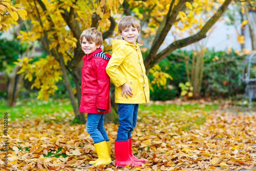 Two little best friends and kids boys autumn park in colorful clothes. Two little best friends and kids boys autumn park in colorful clothes.
