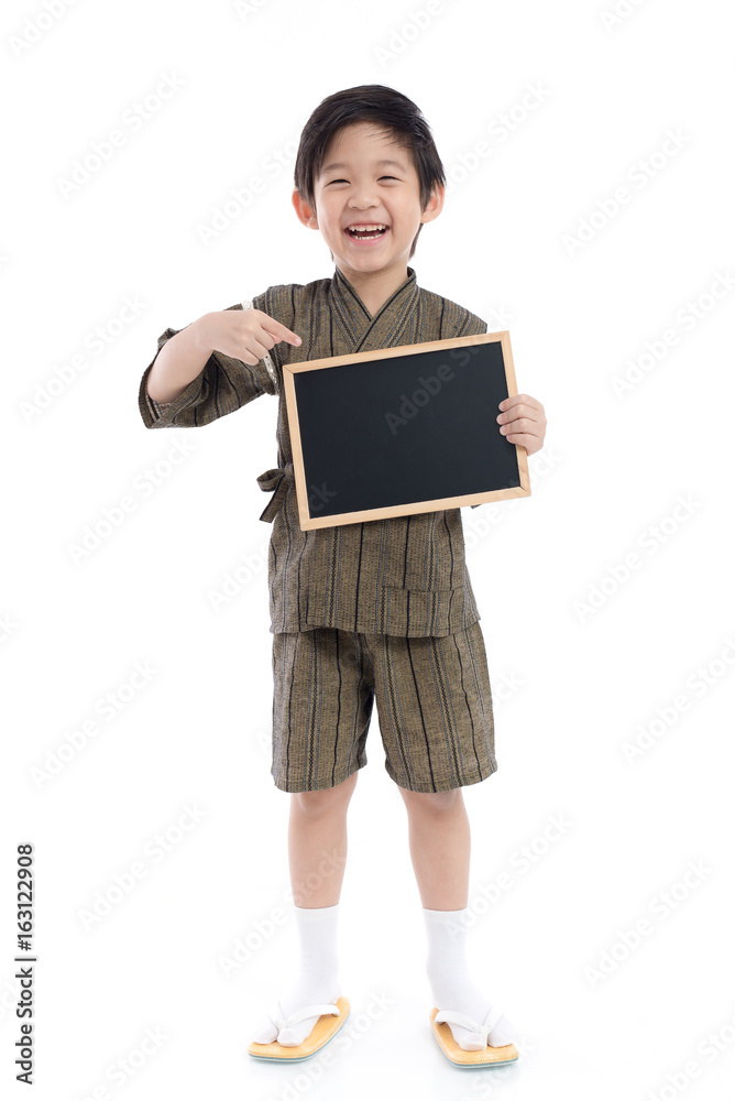 Cute asian boy in kimono holding black board on white background isolated Cute asian boy in kimono holding black board on white background isolated