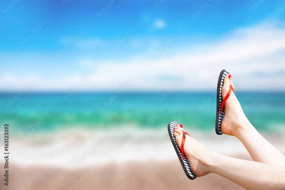 Naklejka premium female legs on the beach