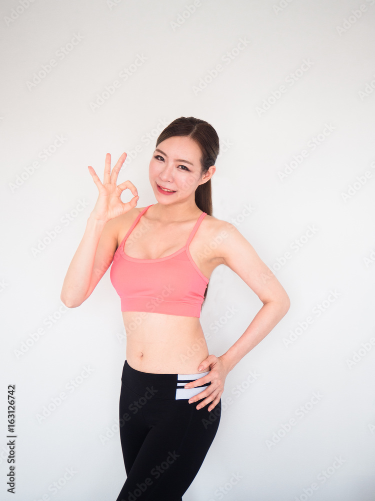 sport woman show ok sign with finger and posing on white background,fitness concept sport woman show ok sign with finger and posing on white background,fitness concept