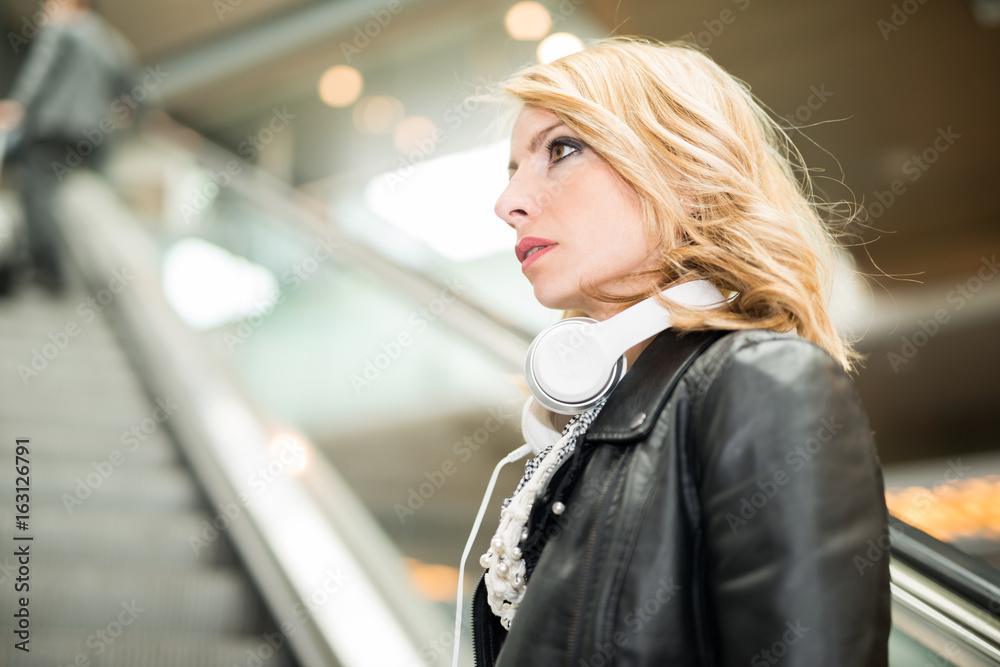 Woman lifting an escalator