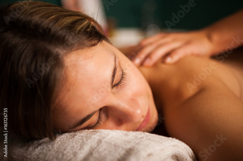 Relaxed woman receiving a massage