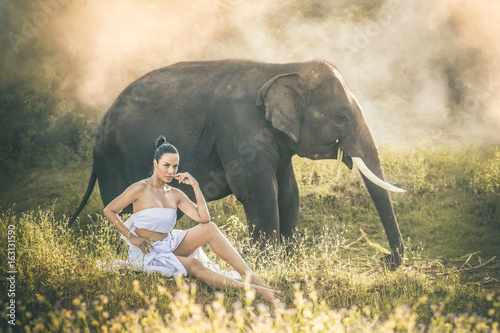 Photography Women wearing white clothes and the elephants in the forest.