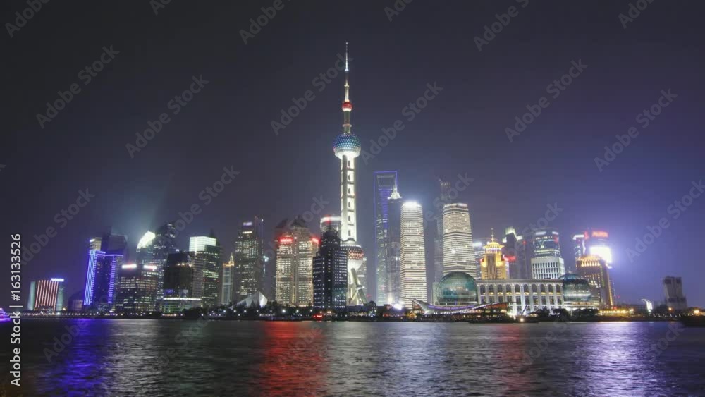 Time lapse of Shanghai skyline and tour boat passing in the Huangpu river at nigh, China. Time lapse of Shanghai skyline and tour boat passing in the Huangpu river at nigh, China.