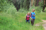 happy little boy and girl run to school