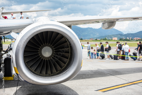 Engine turbine with passengers boarding on the plane © trattieritratti