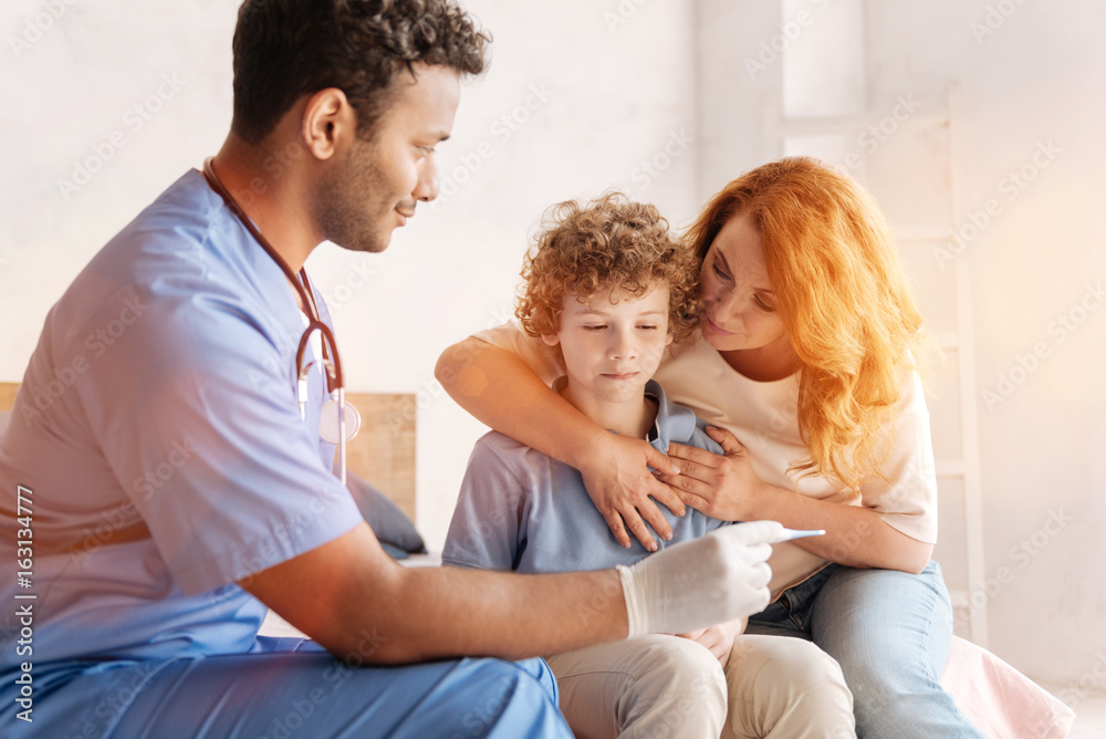 Kind mother embracing her son while visiting doctor Kind mother embracing her son while visiting doctor