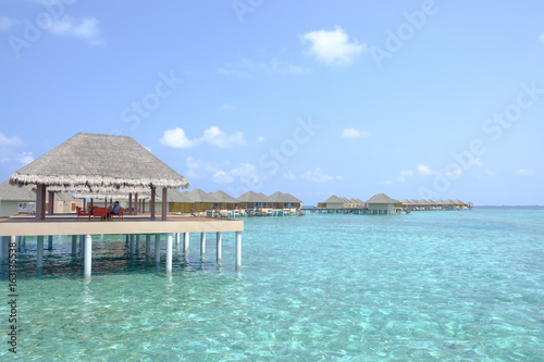 Beautiful dappled water surrounds the colony of water bungalows. Maldives Island.