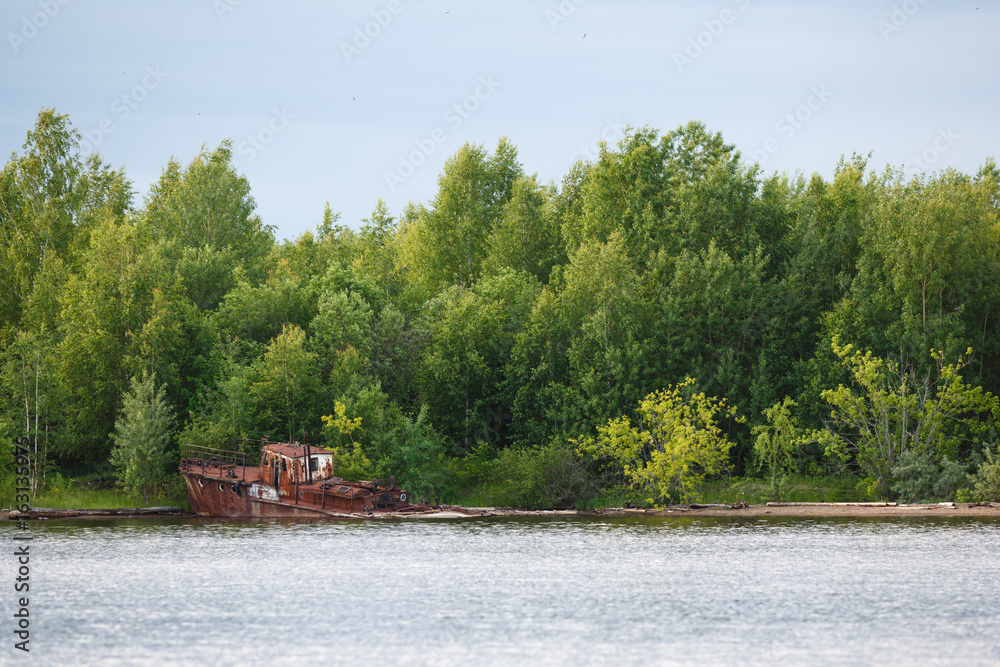 Old rusty sunken ship in water