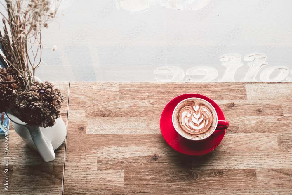 Coffee latte art on wooden table in coffee shop Coffee latte art on wooden table in coffee shop