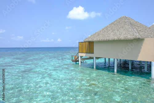 blue sky and crystal clear sea water over the water bungalow