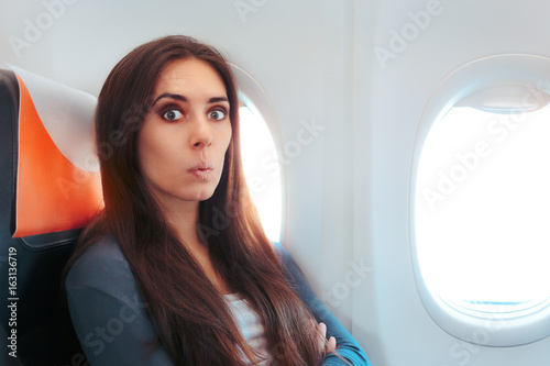 Funny Surprised Woman Sitting By the Window on An Airplane
