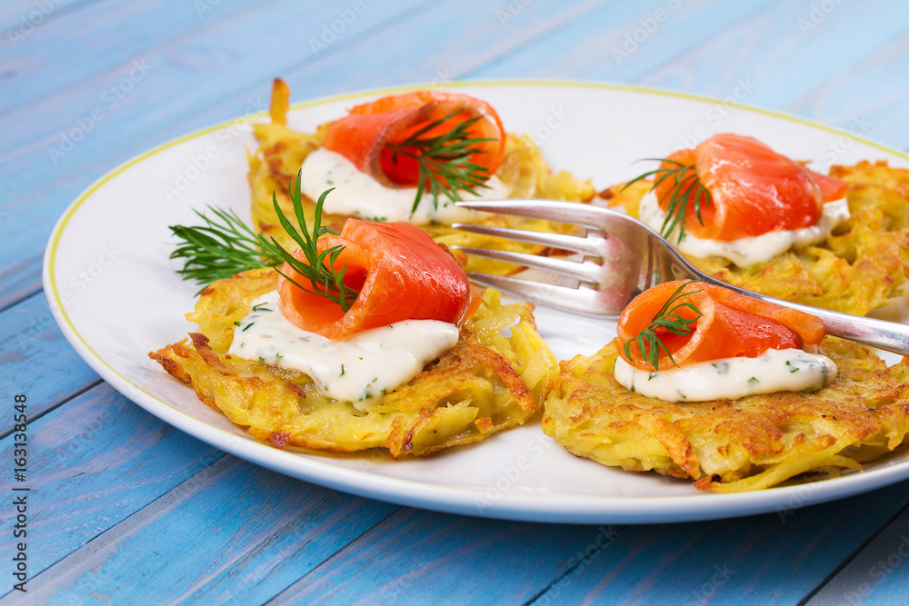 Potato Pancakes With Smoked Salmon. Vegetable fritters with fish. Latkes on a plate