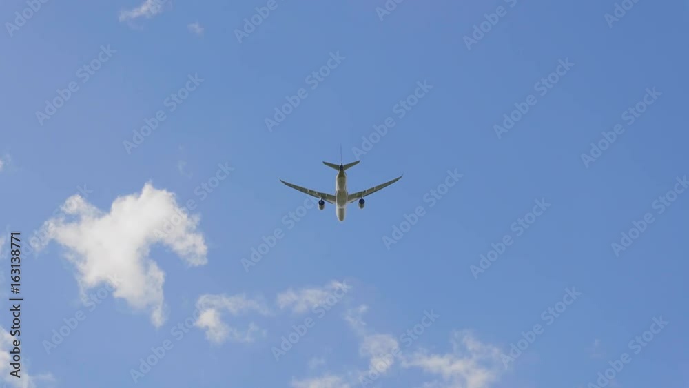 Commercial passenger airplane flying overhead on sunny day. UltraHD stock footage. Commercial passenger airplane flying overhead on sunny day. UltraHD stock footage.