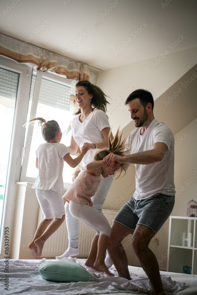 Fototapeta premium Happy family having fun on bed.