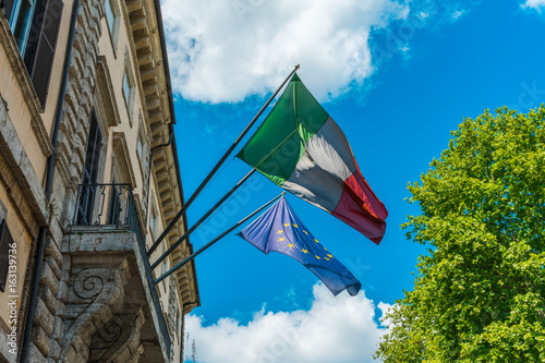 Fototapeta Naklejka Na Ścianę i Meble -  italy and europe flag on an italian building