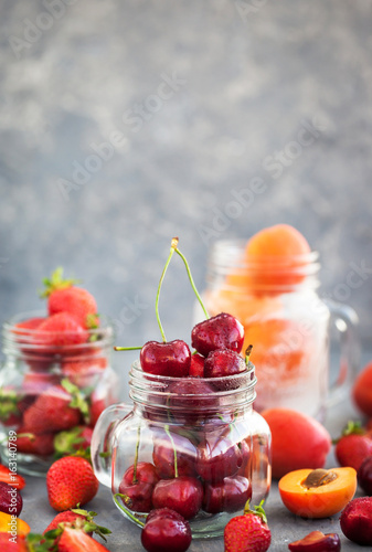 Fresh ripe summer cherry, strawberry and apricots