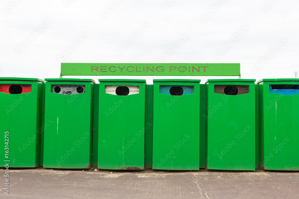 Six green recycling bins by recycling point to collect rubbish Six green recycling bins by recycling point to collect rubbish