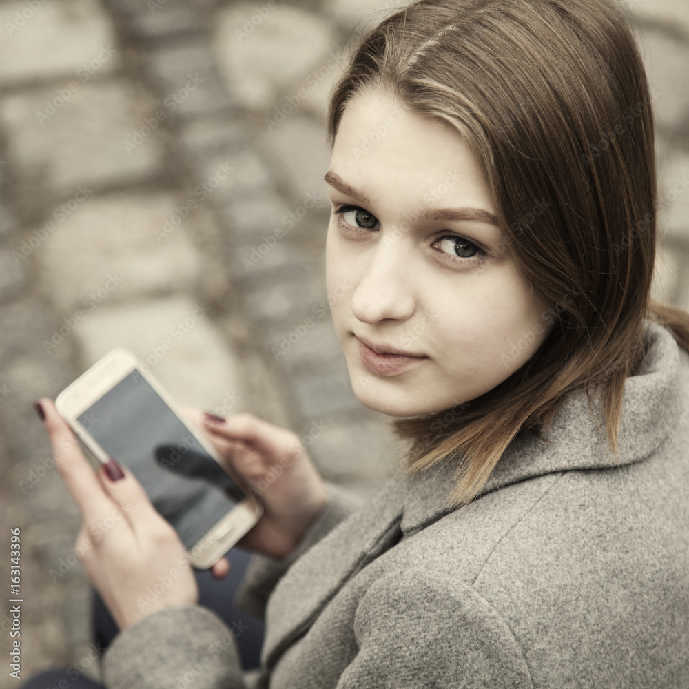Social Media addiction. young beautiful woman holding a smartphone (psychological problems, media mania) Social Media addiction. young beautiful woman holding a smartphone (psychological problems, media mania)