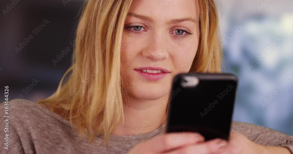 Closeup of pretty girl sending text messages with cell phone Closeup of pretty girl sending text messages with cell phone