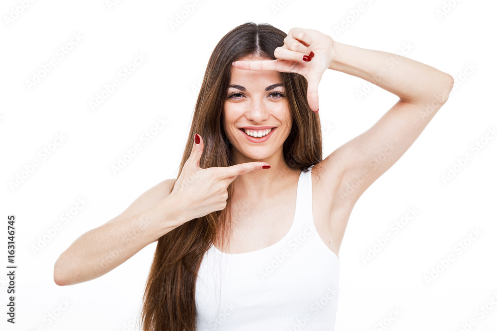 Beautiful young woman making frame with her hands over white background. Beautiful young woman making frame with her hands over white background.
