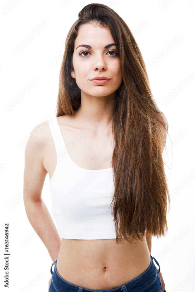 Beautiful young woman looking at camera over white background. Beautiful young woman looking at camera over white background.