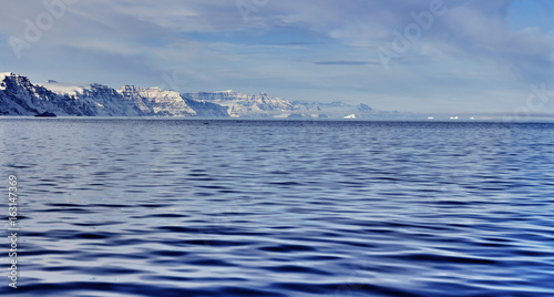 iceberg floating in greenland fjord