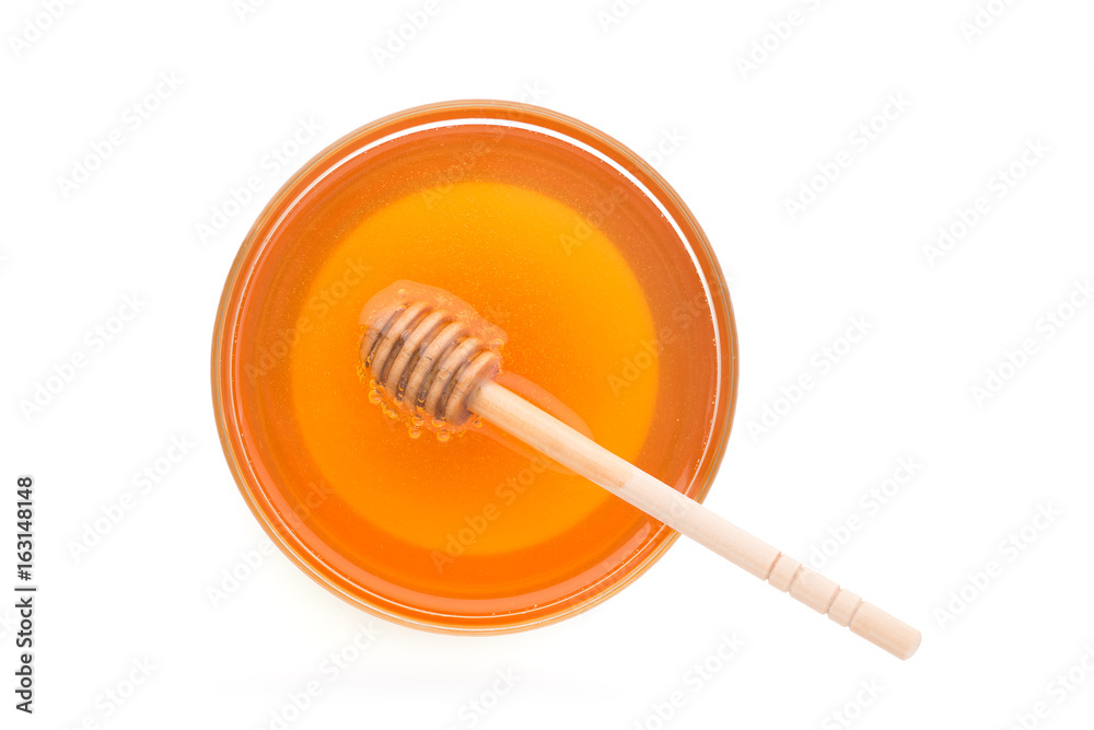 Wooden dipper with bowl of honey, isolated on the white background Wooden dipper with bowl of honey, isolated on the white background