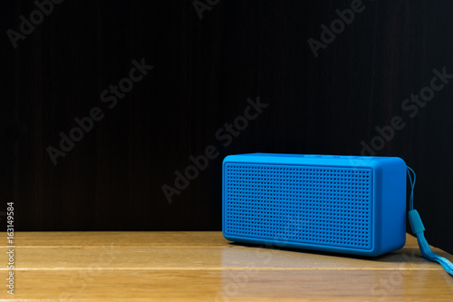 blue speaker on the table.