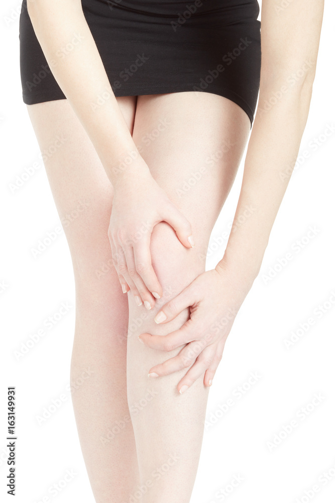 Woman with black dress with knee and legs pain isolated on white, clipping path