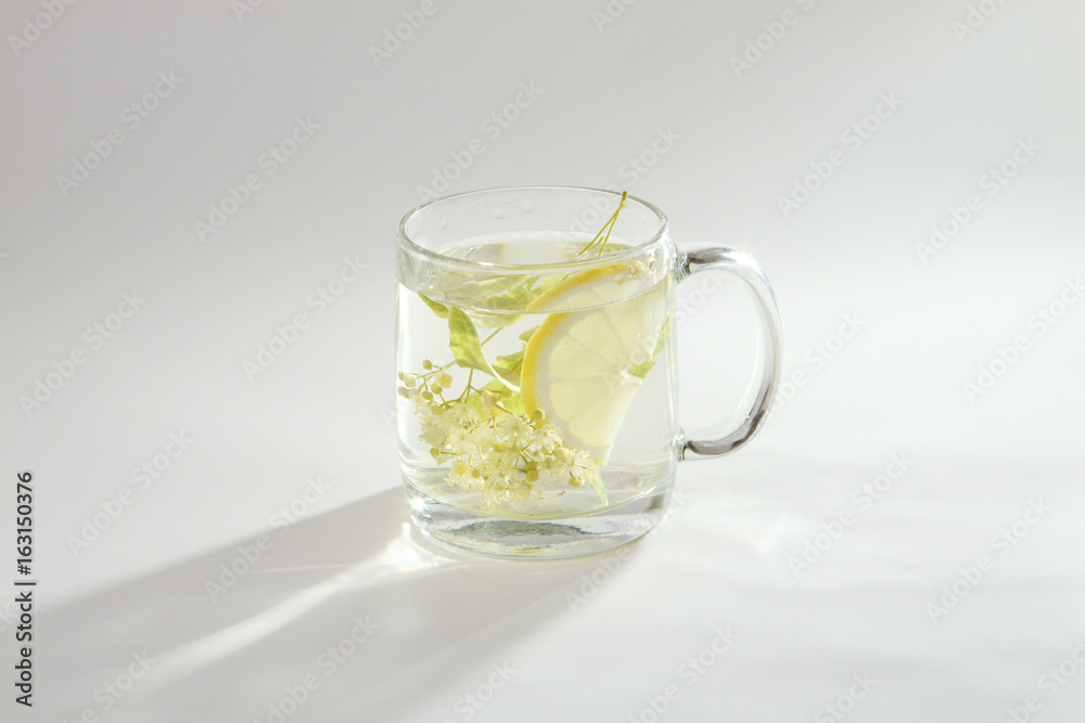 Lime tea with lemon in a glass cup Lime tea with lemon in a glass cup