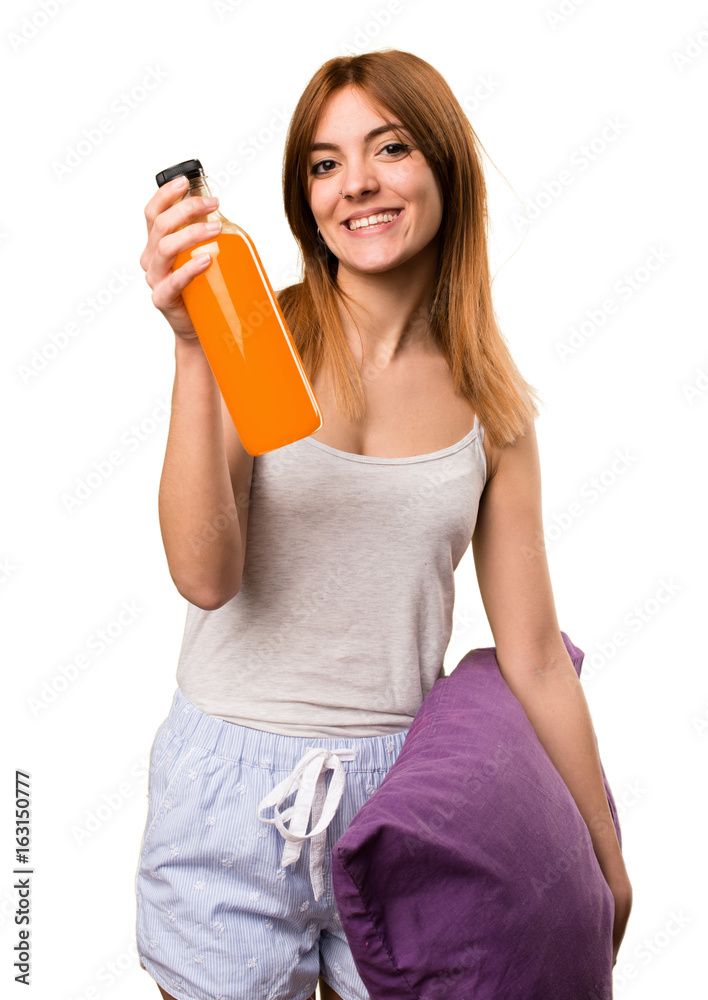 Beautiful girl in pajamas holding an orange juice Beautiful girl in pajamas holding an orange juice