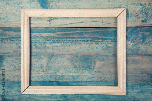Photo frame on wooden background