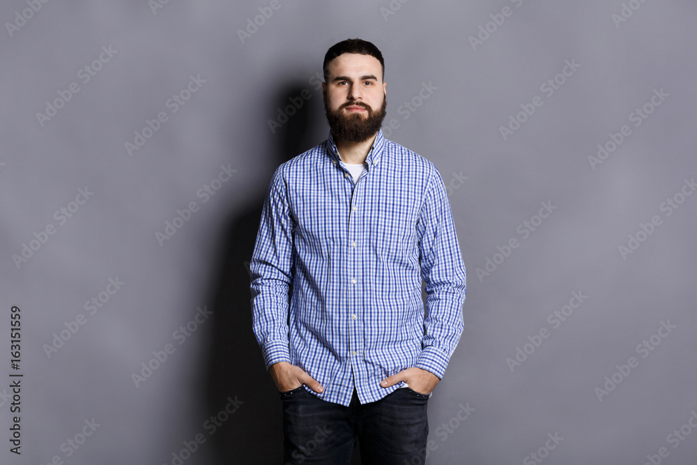 Handsome bearded man posing with hands in pocket Handsome bearded man posing with hands in pocket