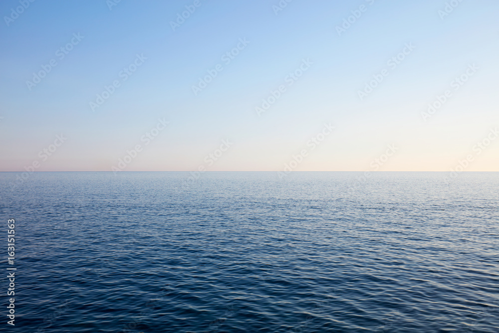 Obraz premium Mediterranean blue, calm sea and horizon, clear sky in Italy