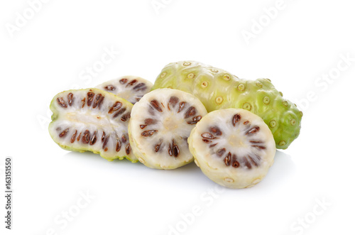 Quadro su tela whole and sliced fresh noni fruit on white background