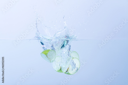 Green Apples splashing in water