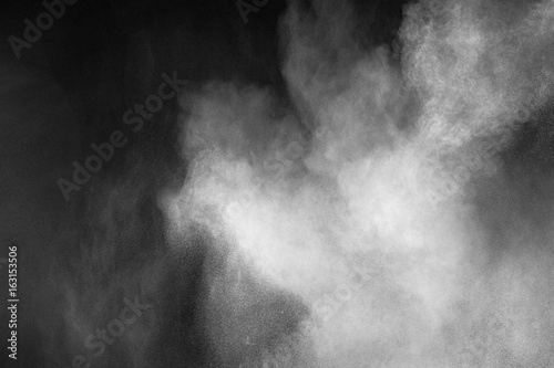 Freeze motion explosion of white dust on  black background.