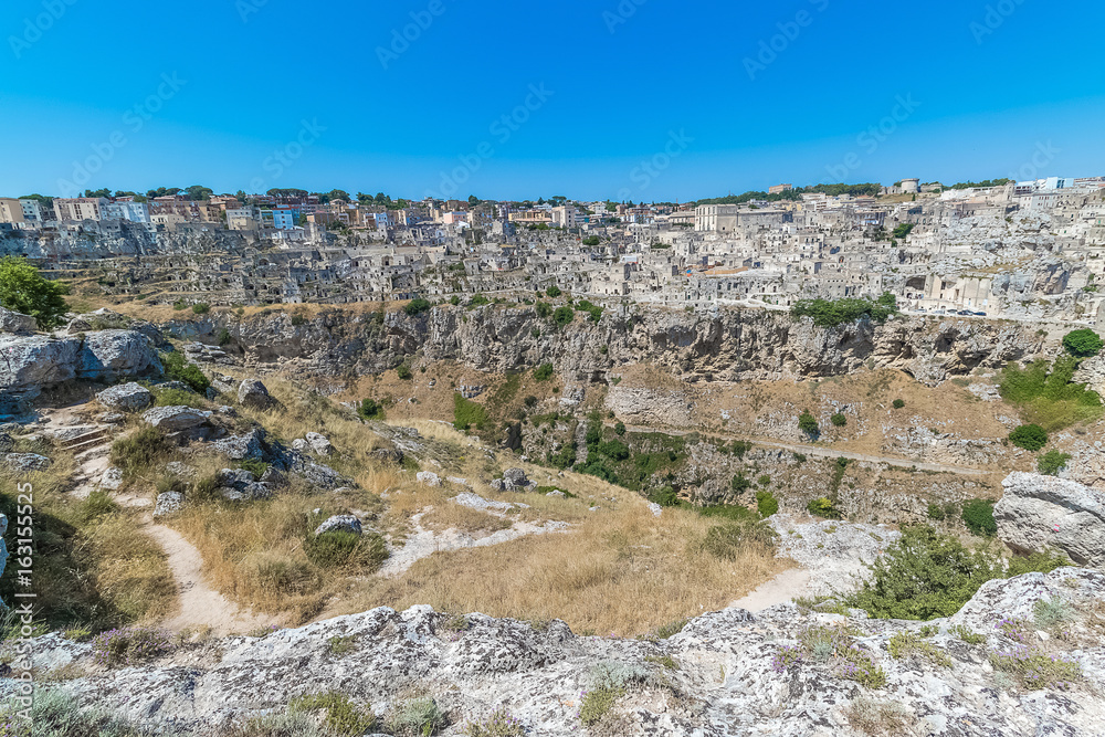 panoramic view of typical stones house (Sassi di Matera) of Matera UNESCO European Capital of Culture 2019 under blue sky. Basilicata